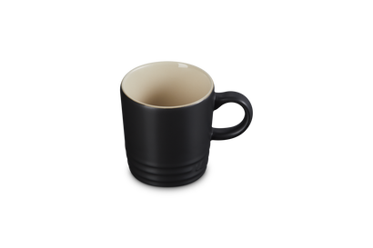 Black mug with beige interior on a white background